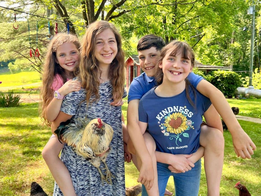 two sisters holding siblings on their backs