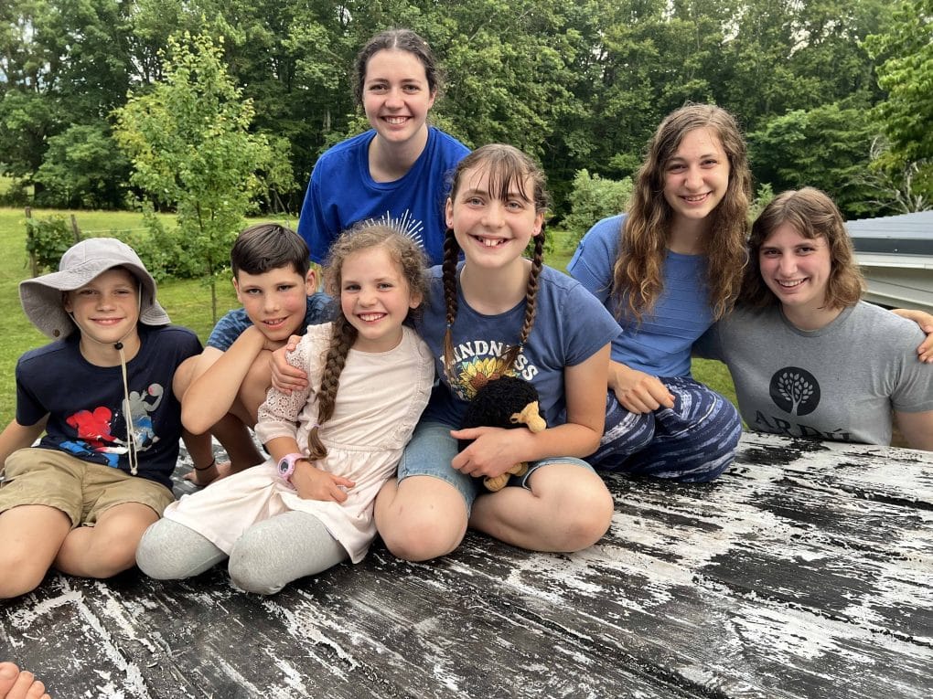siblings posing on roof