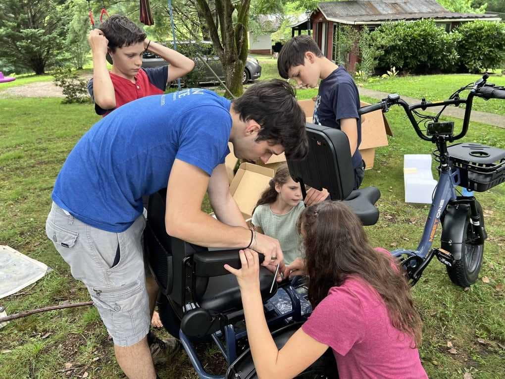 siblings assembling an etrike