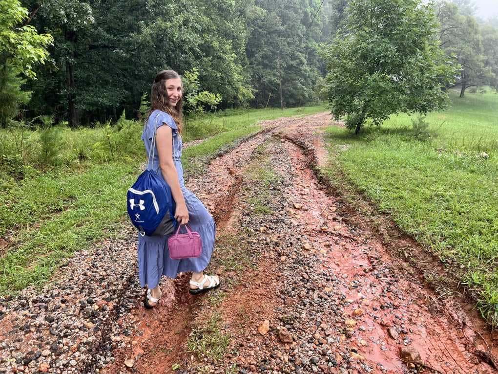 girl walking down a washed out driveway