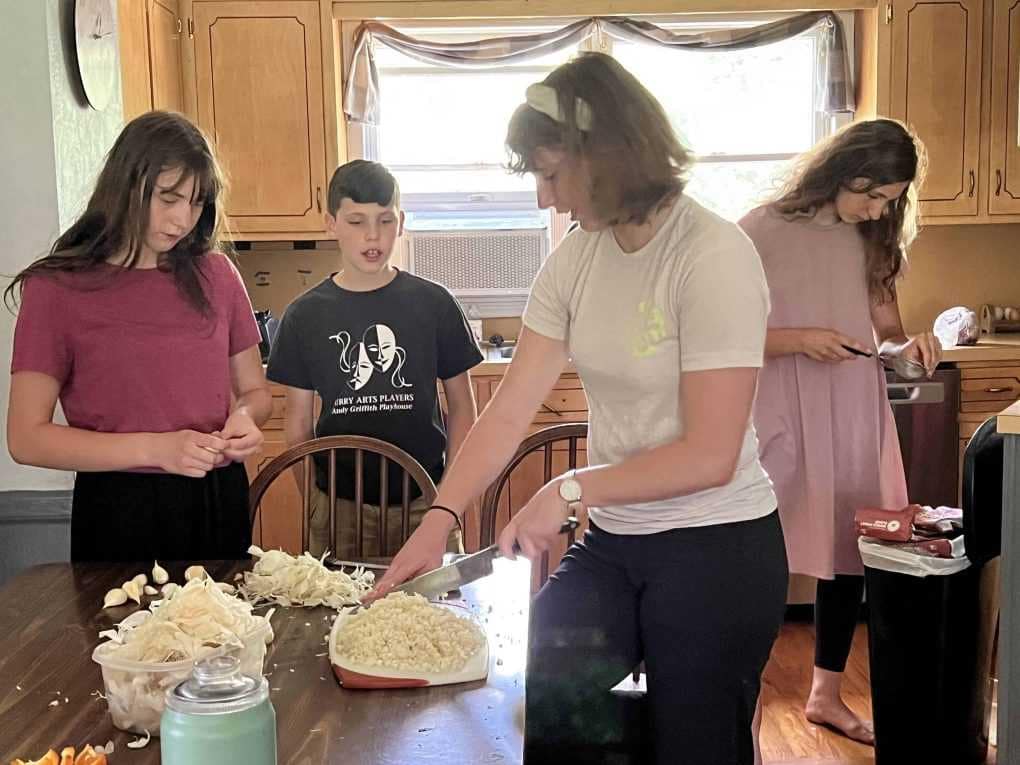 children chopping fresh picked garlic