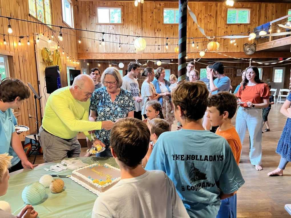older couple cutting cake at 50th anniversary