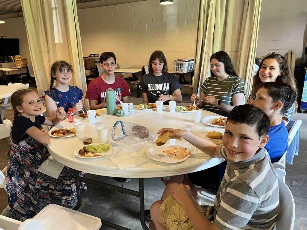family eating around table at family reunion