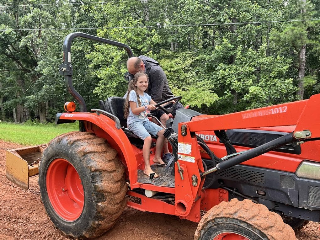 girl riding on a tractor