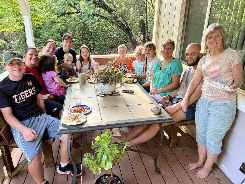 family eating at a table outside