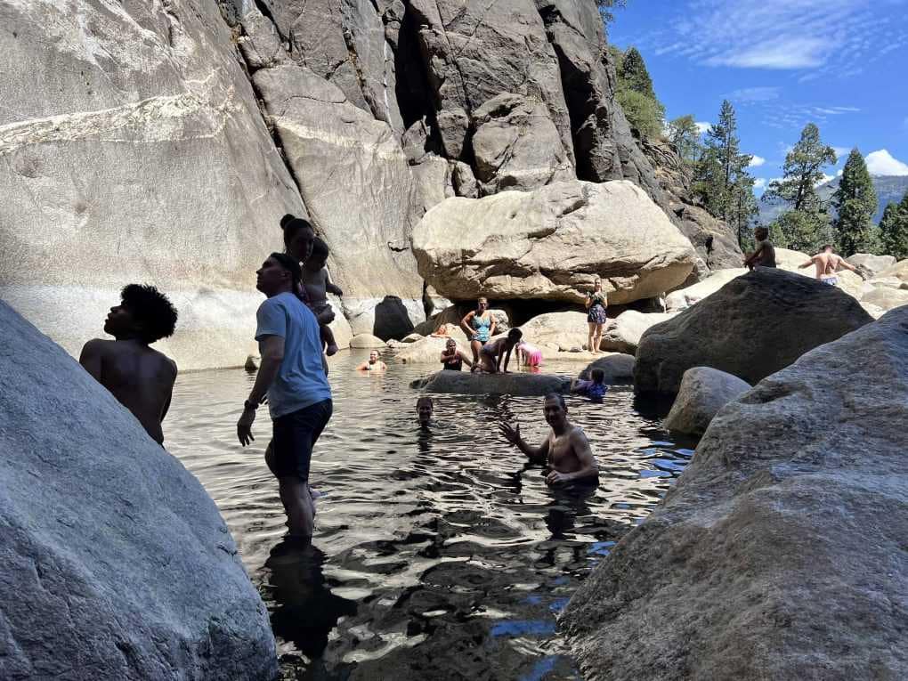 family playing in water at Yosemite