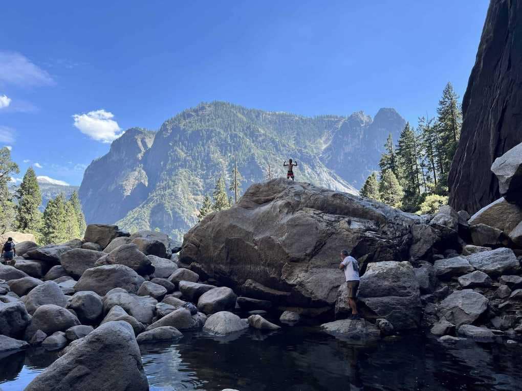 kid standing on boulder at Yosemite
