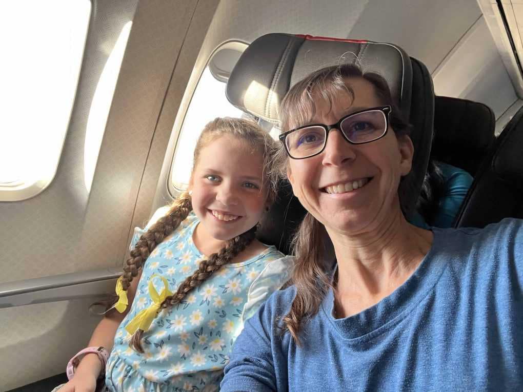 mom and daughter on airplane