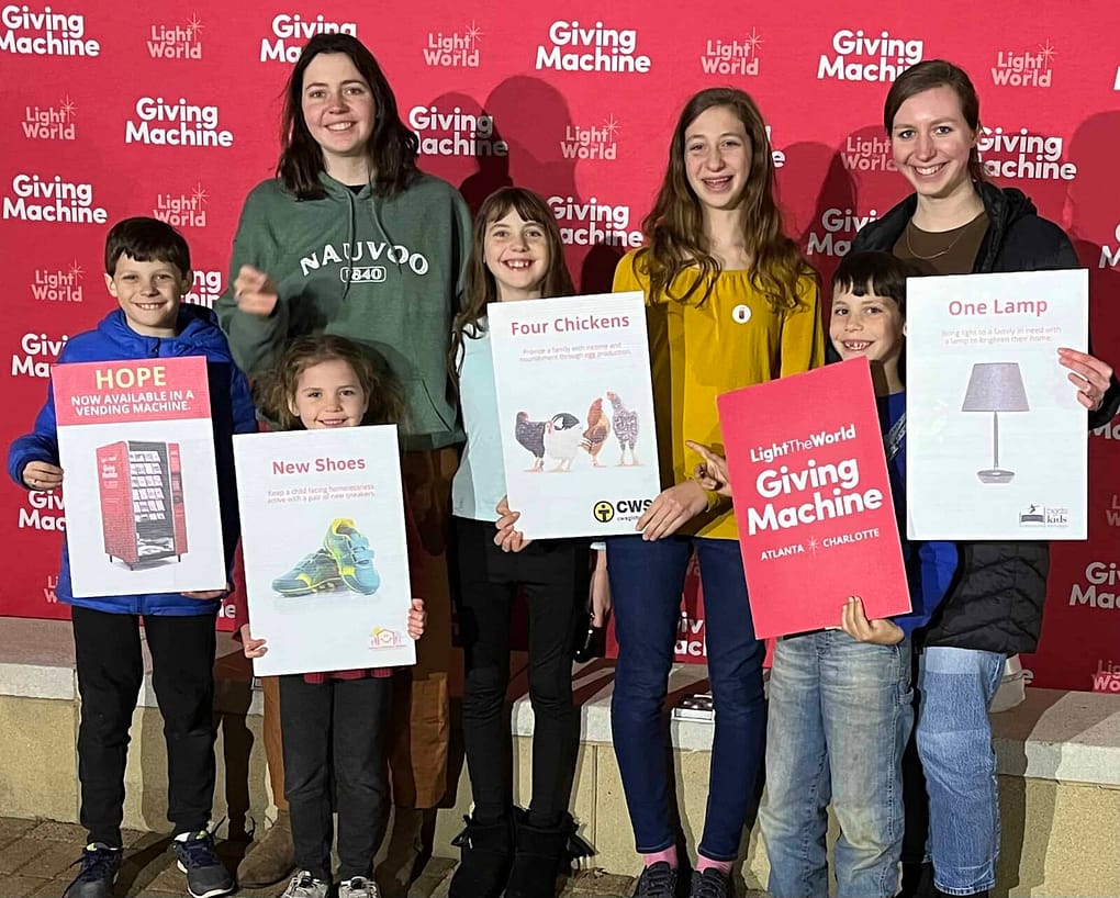 kids donating to light the world giving machine