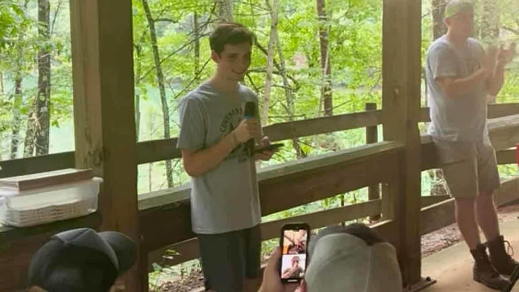 boy talking into microphone at camp