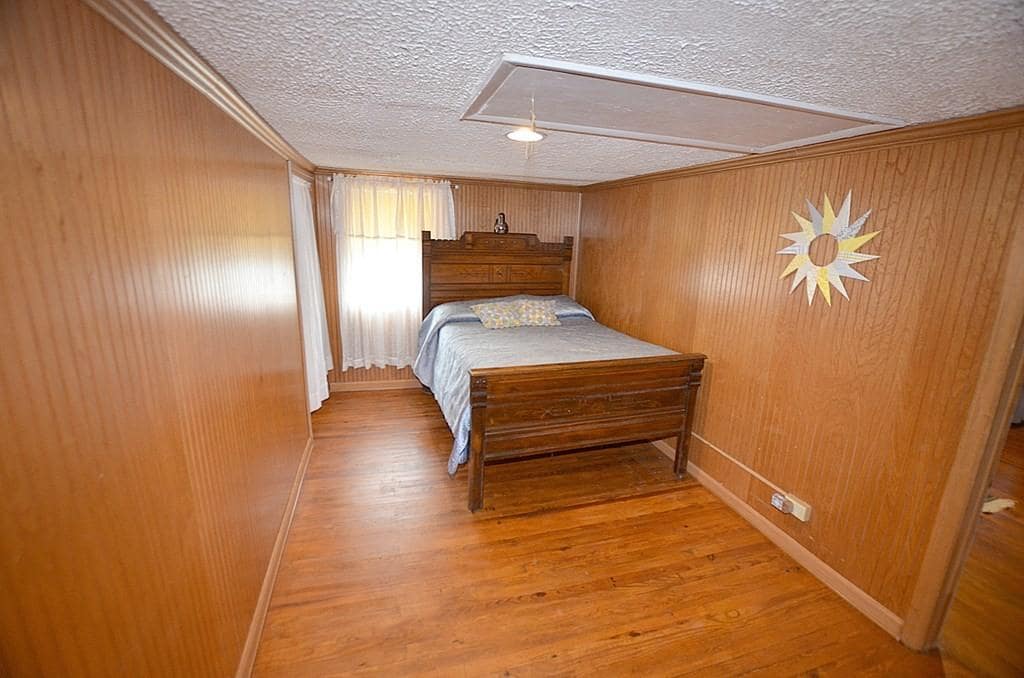 wood paneled bedroom