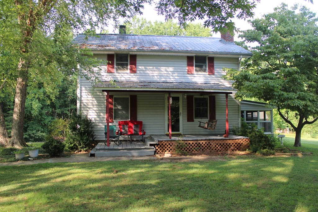 1930's white farmhouse with red shutters in the Blue Ridge Mountains