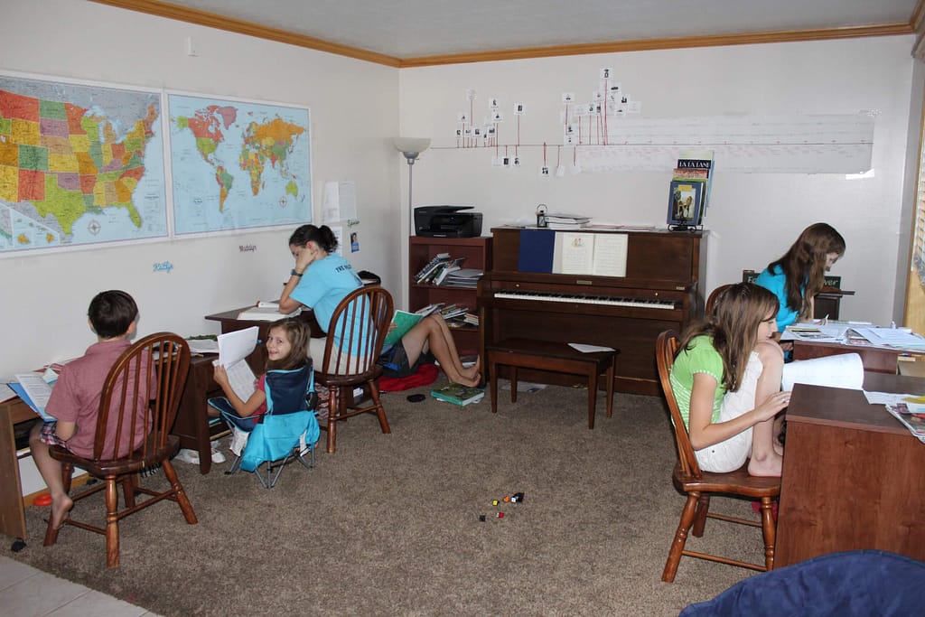 6 kids sitting at desks in their homeschool classroom