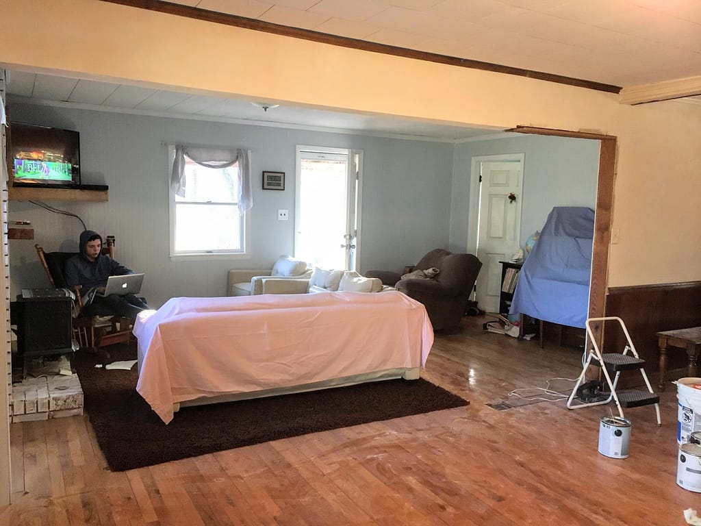 sanding and painting a major beam in the dining room, living room