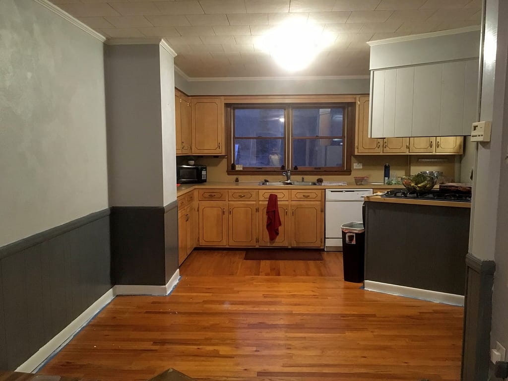 dining room wood paneling, walls and trim painted light and dark gray