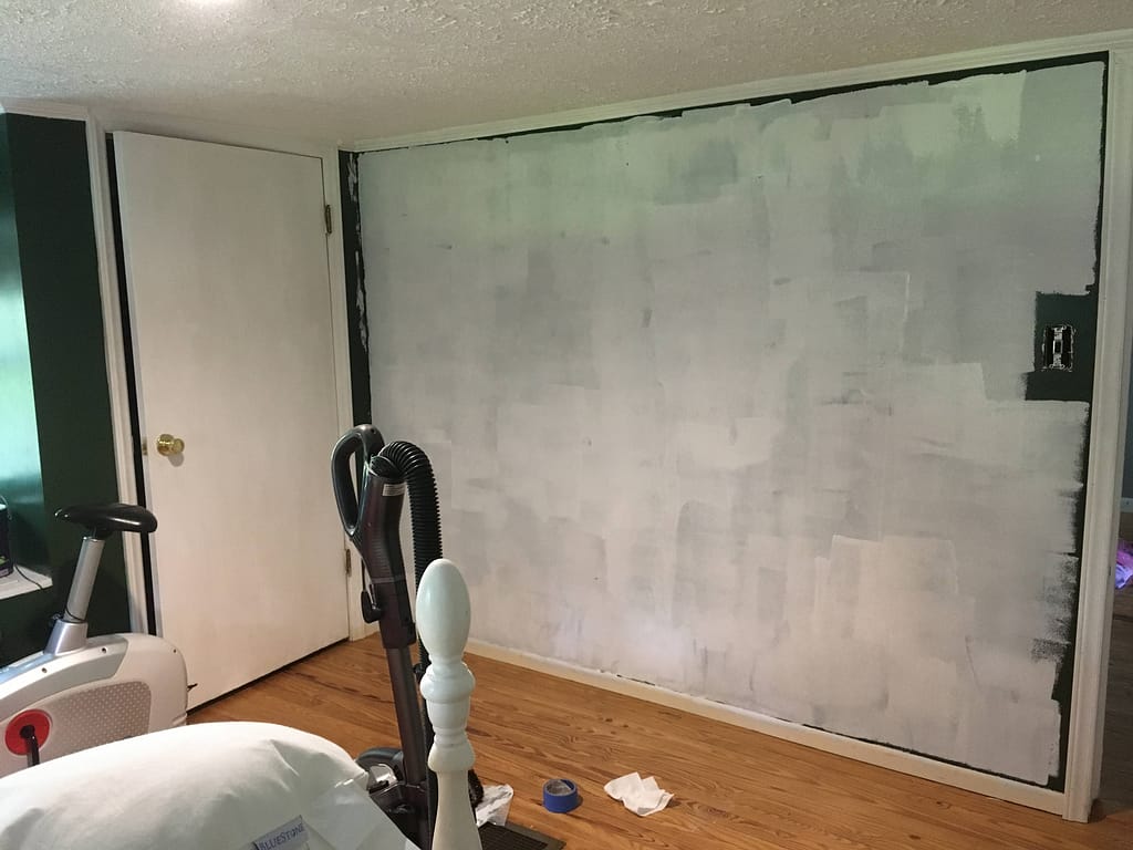 putting primer on a bedroom wall