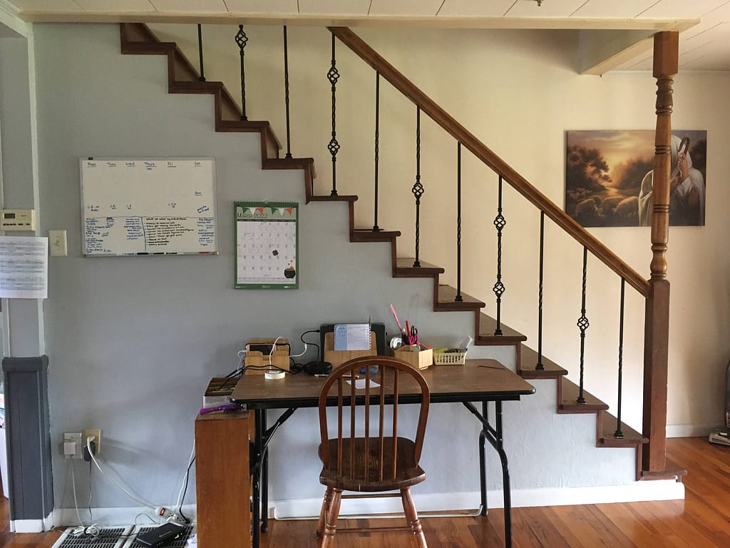Staircase with new black metal hollow core balustrades installed in a home.