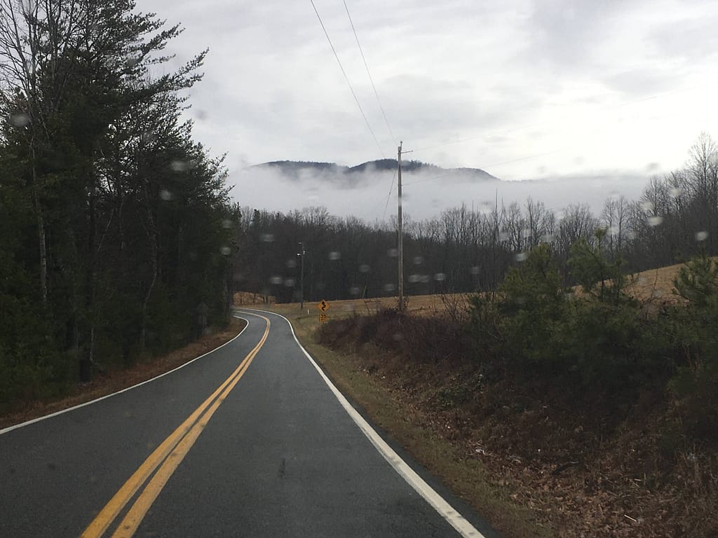 view from a car of the fog against the blue ridge parkway up ahead