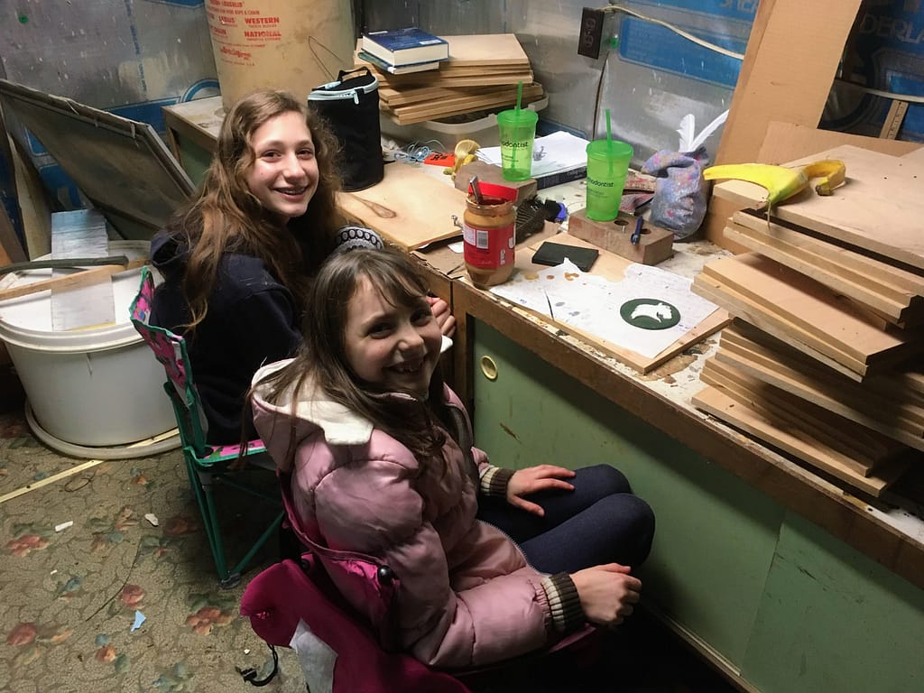 Two girls playing in an old office shed.