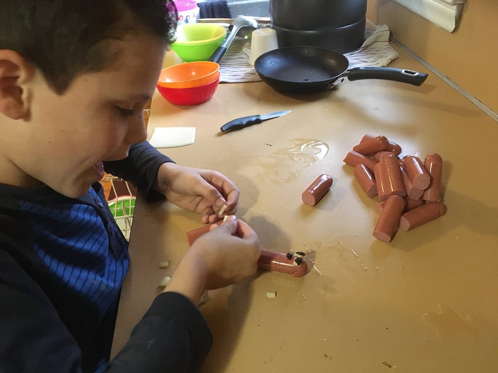 boy making groundhog hotdogs