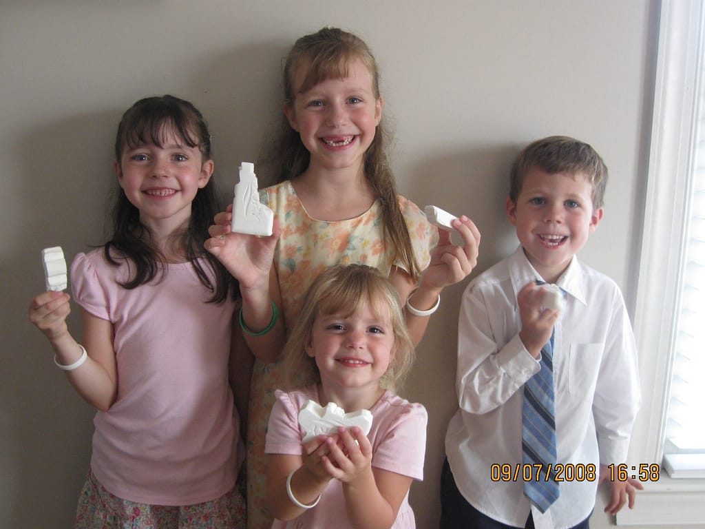 4 kids show their soap sculptures they made in homeschool
