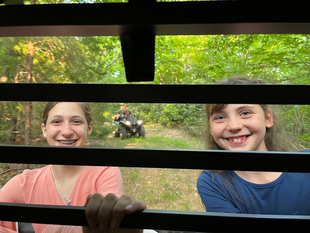 two girls on the back of a mule ride
