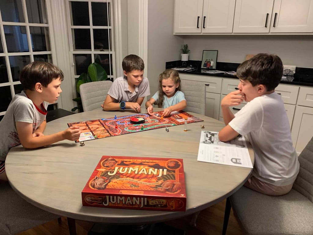 kids playing Jumanji around the table