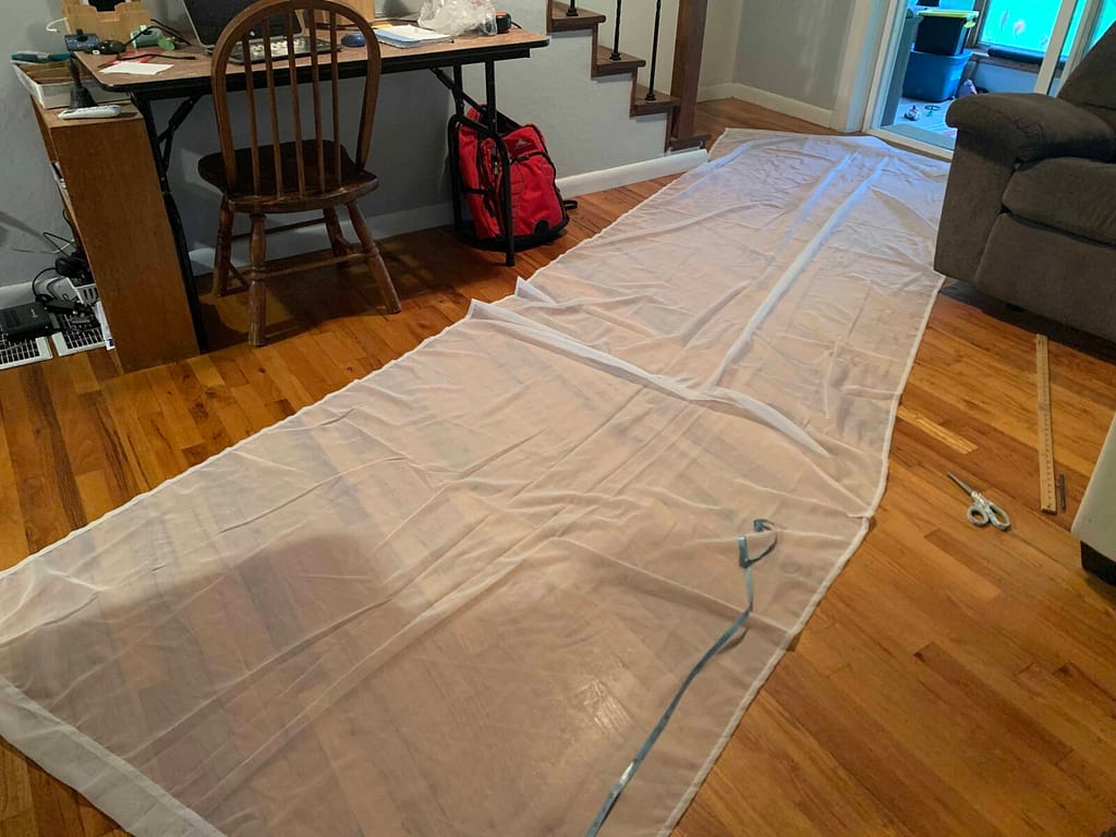 one long curtain laying on the floor