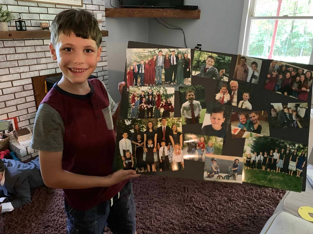boy holding a collage of pictures