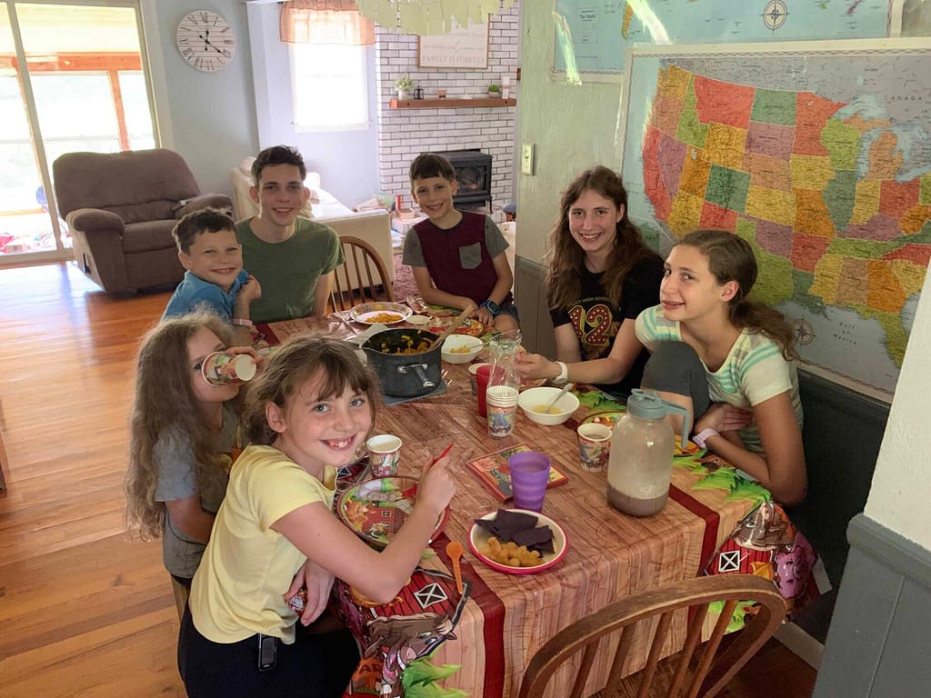 family eating birthday cake around the table