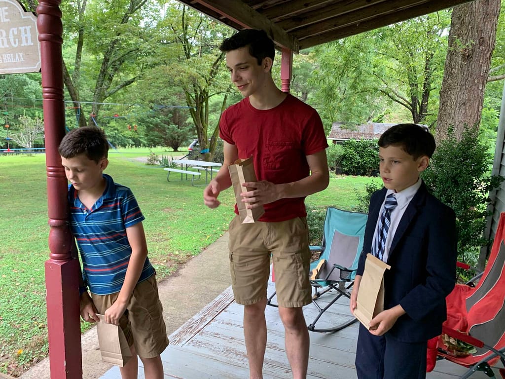 3 boys bidding on 3 picnic baskets of food like in Calpurnia Tate