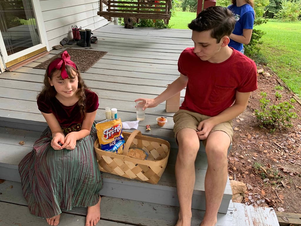 boy and girl share a picnic lunch