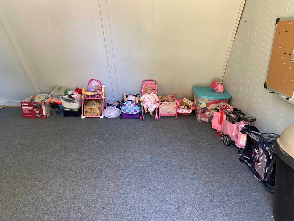 corner of a doll shed with doll stuff