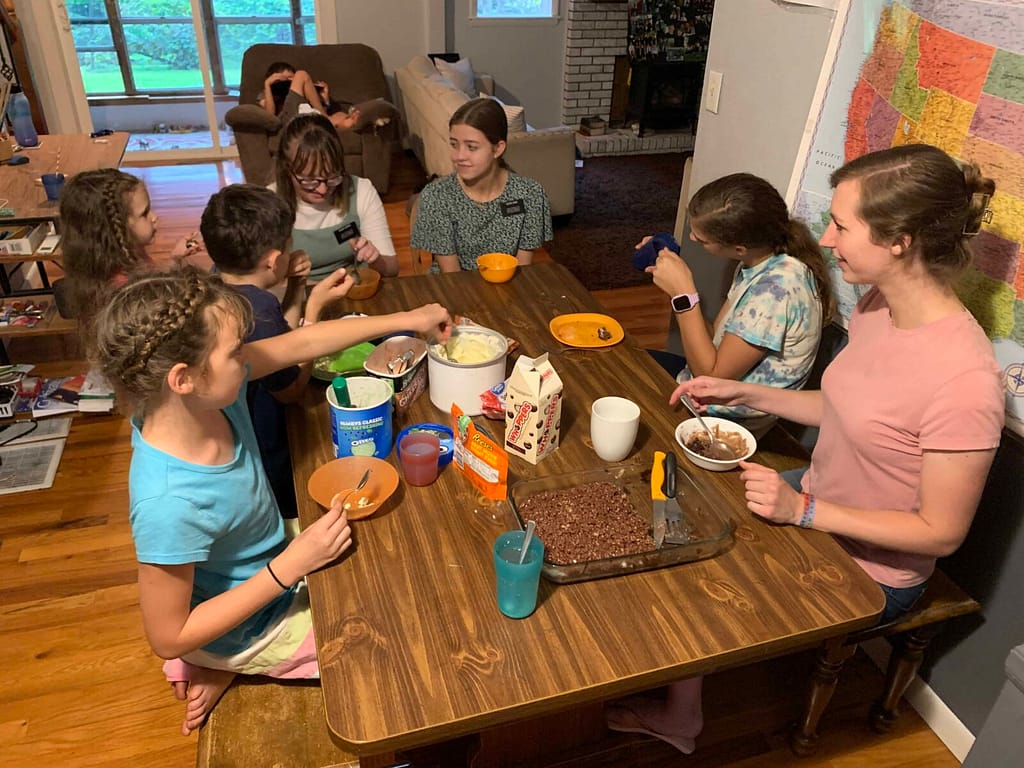 family eating brownies and ice cream around a dining room table