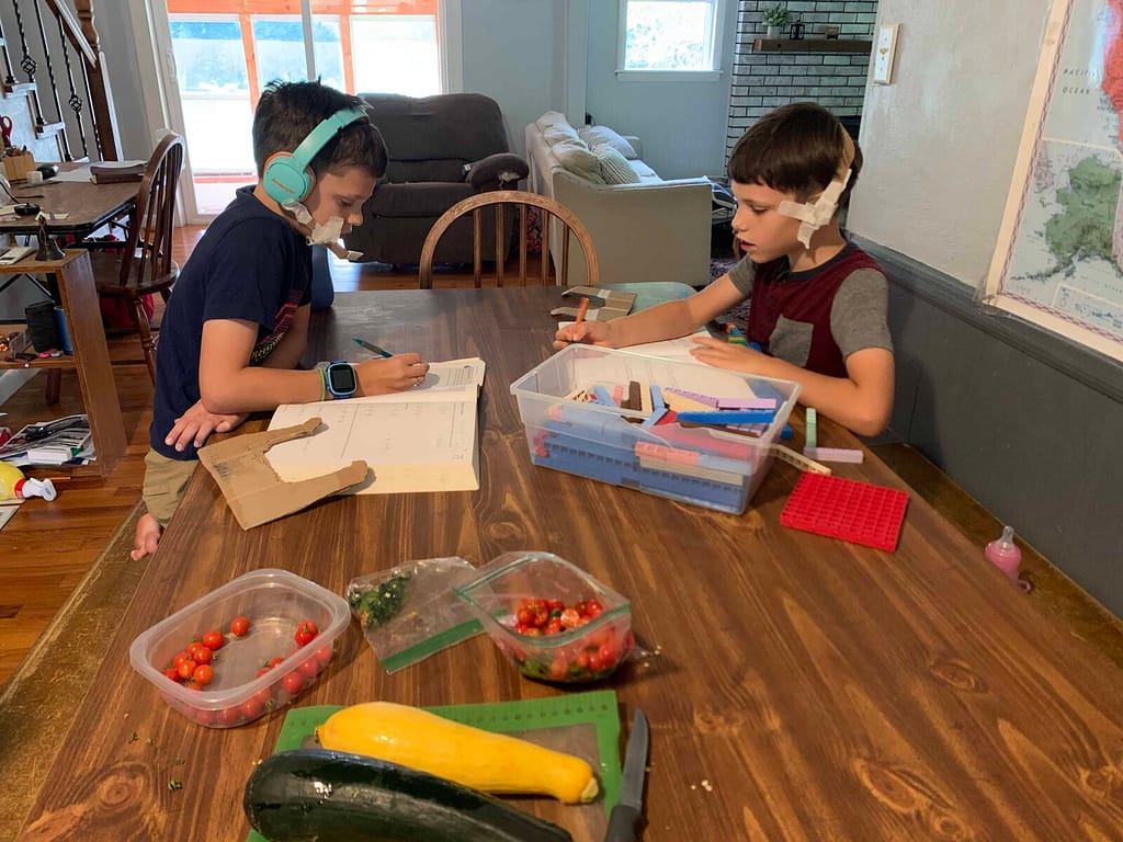 two kids doing math at the table