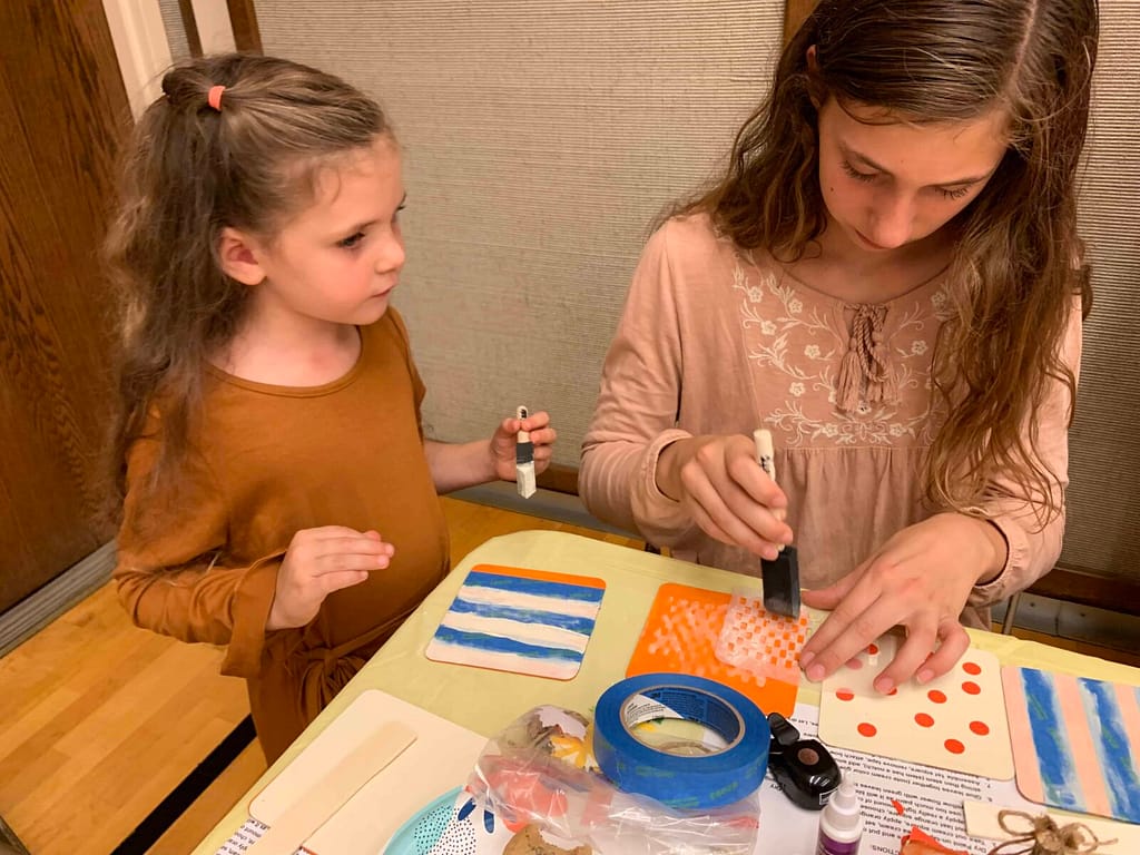 two girls making a fall craft