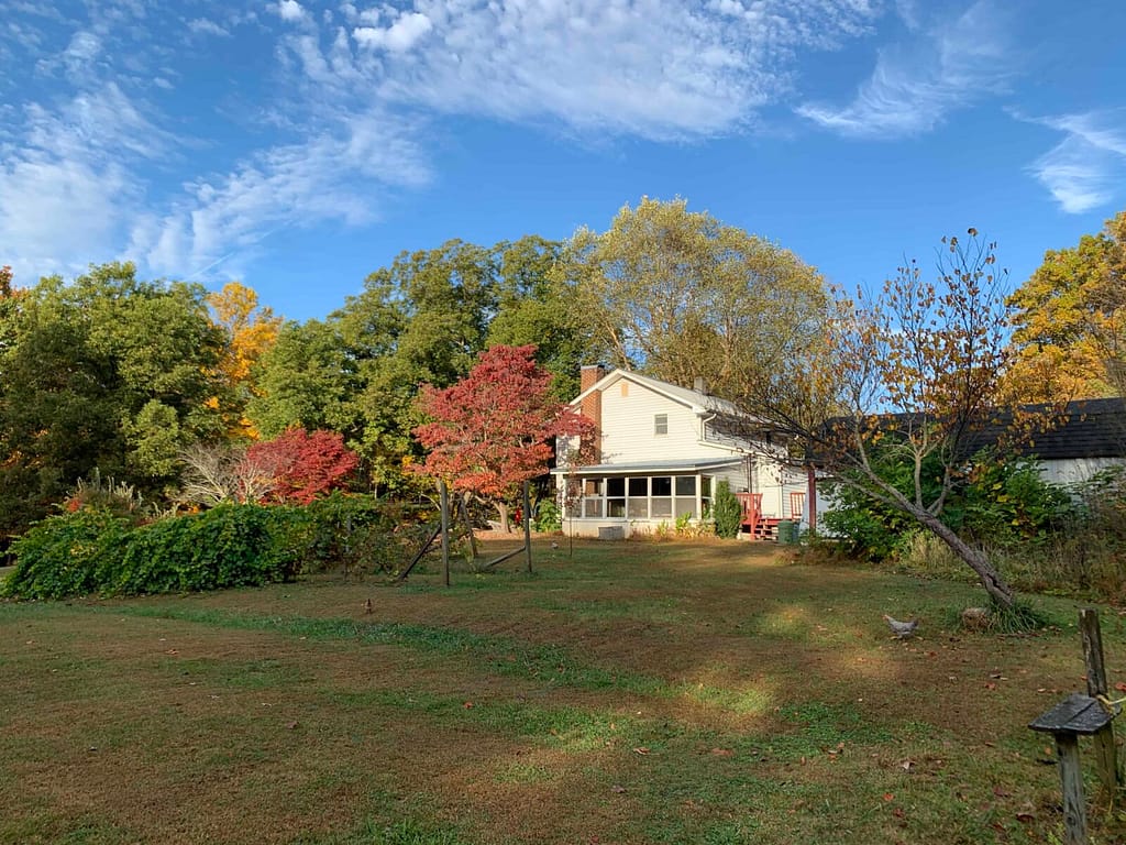 house with fall colors trees around it