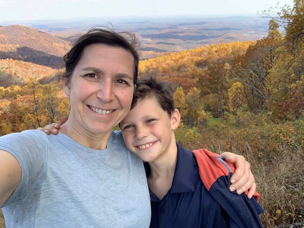 mom and son with blue ridge mountains in back in fall