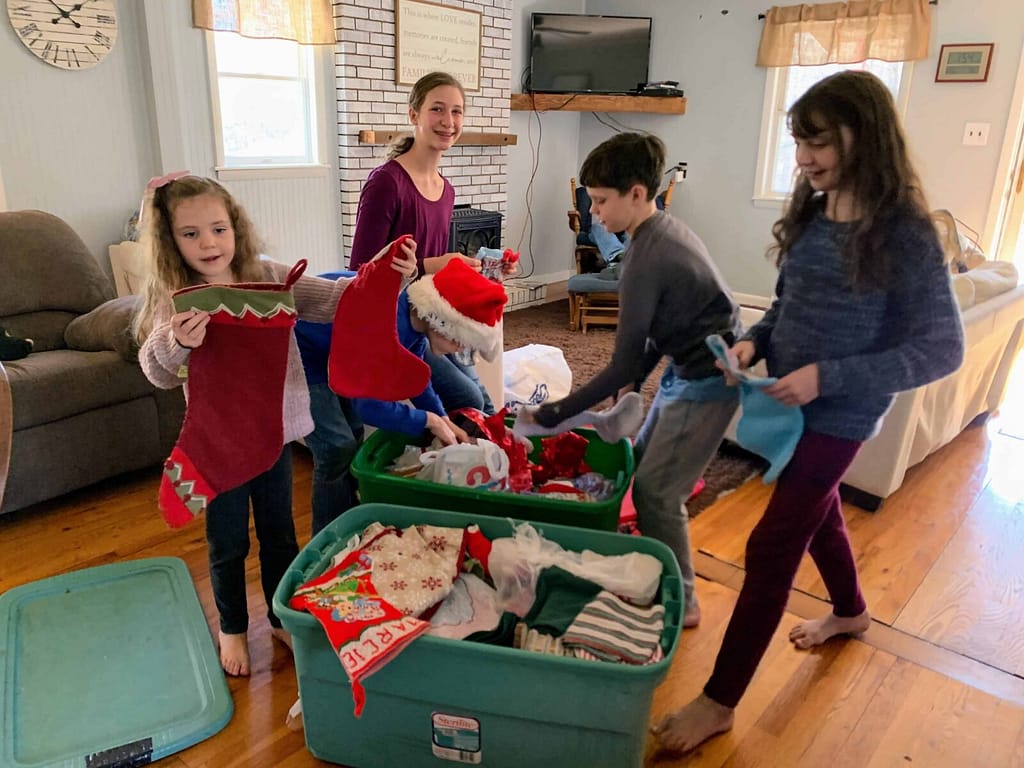 children getting decorations out of a holiday box