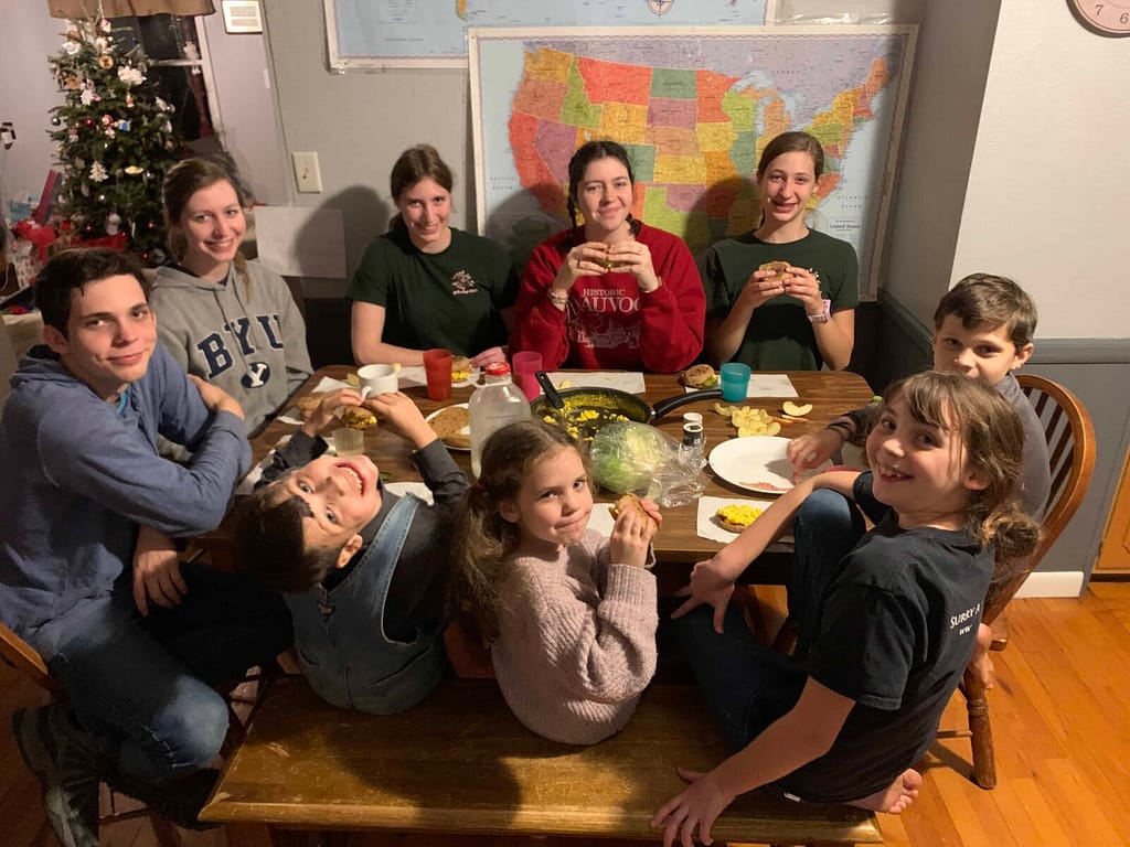 9 kids eating dinner around the table