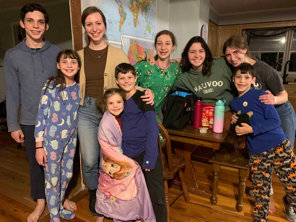 9 kids hugging in their pajamas