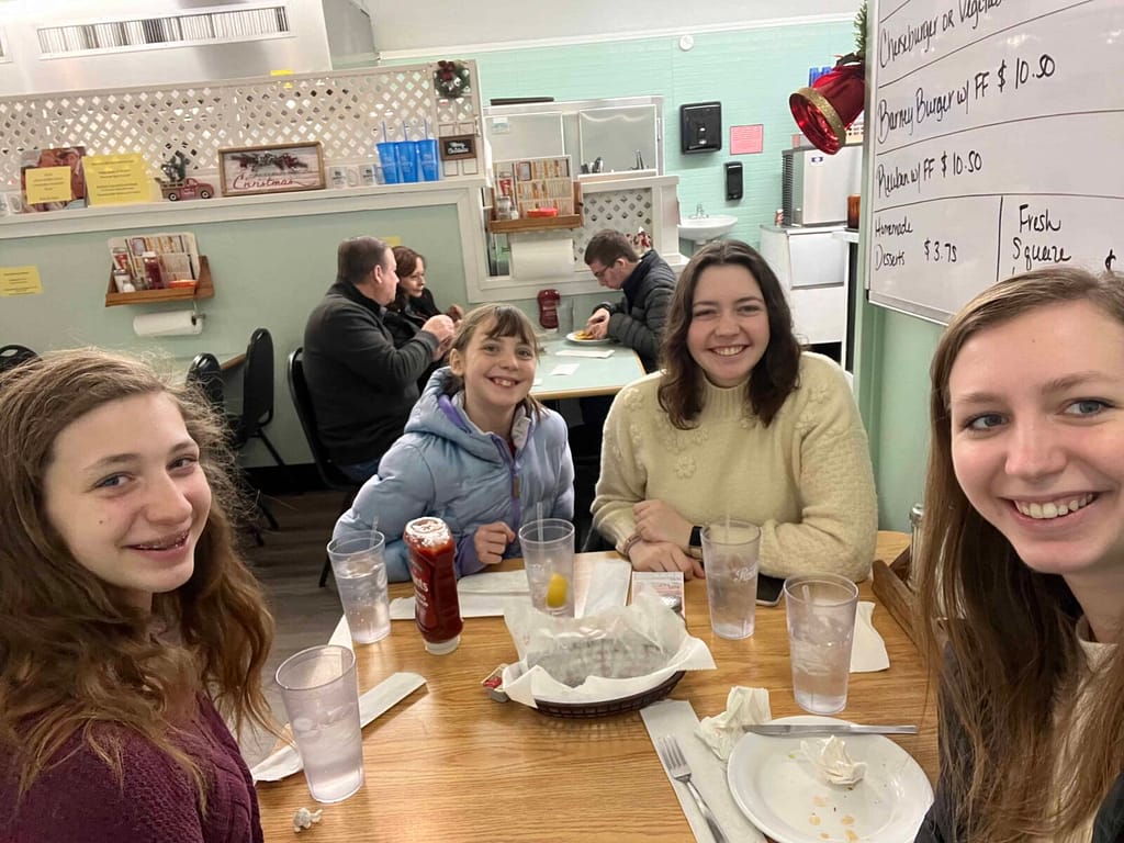4 sisters eating at a restaurant together