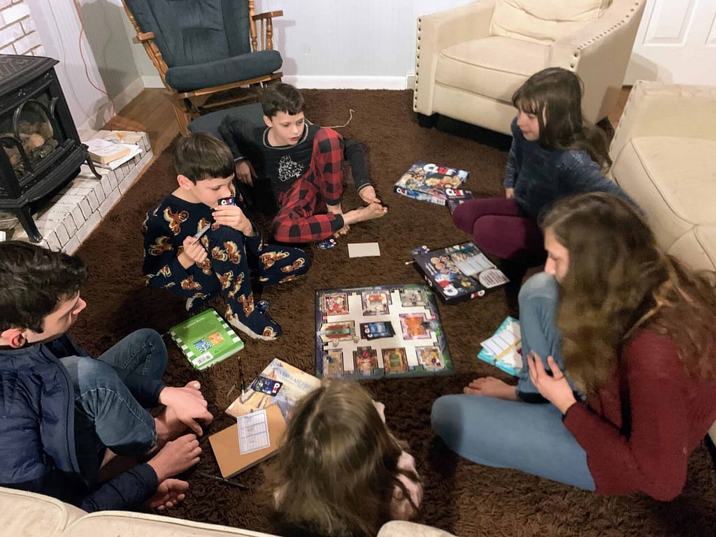 6 kids playing Clue in the living room