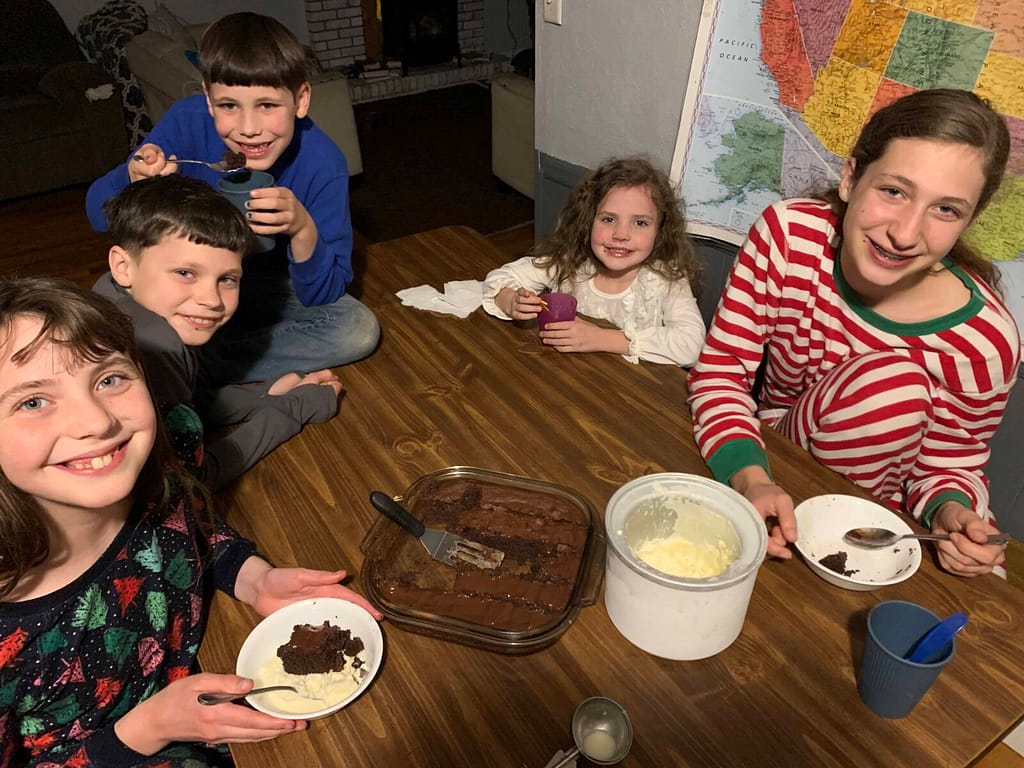 family eating brownies and ice cream at the kitchen table