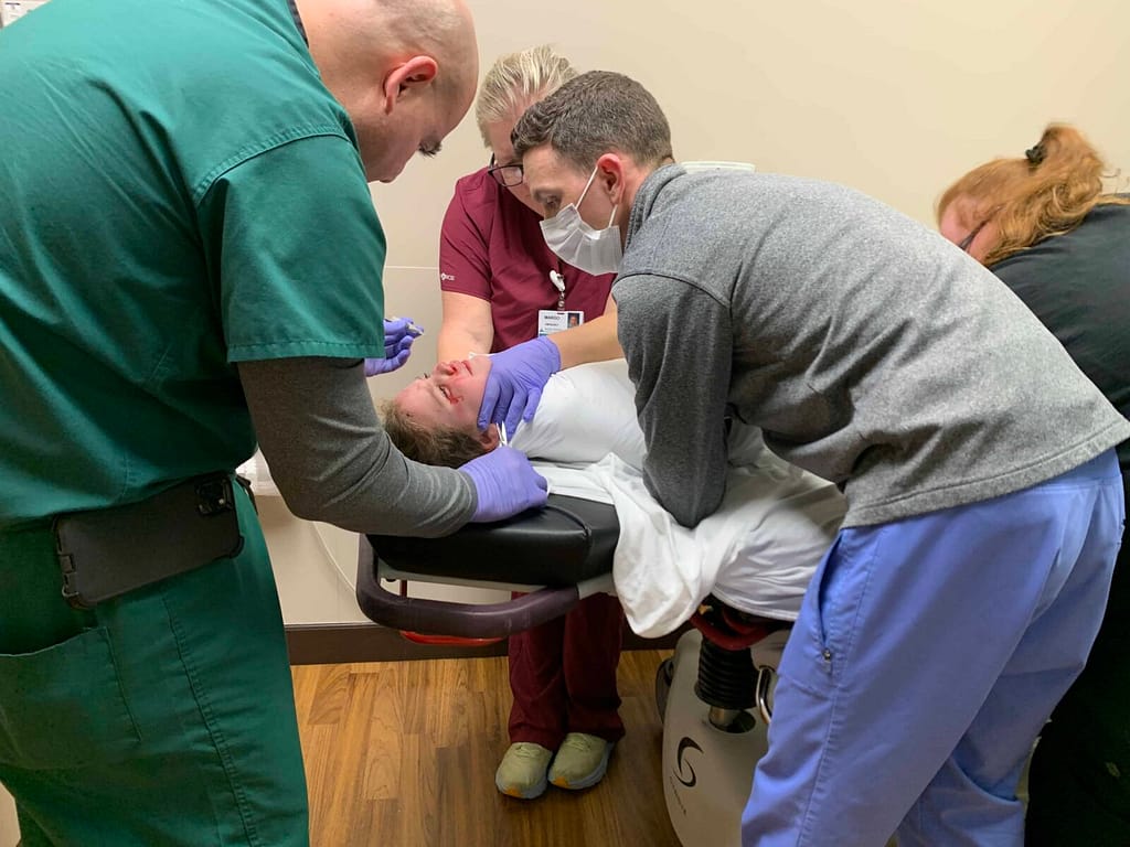 6 year old getting held down to get stitches out