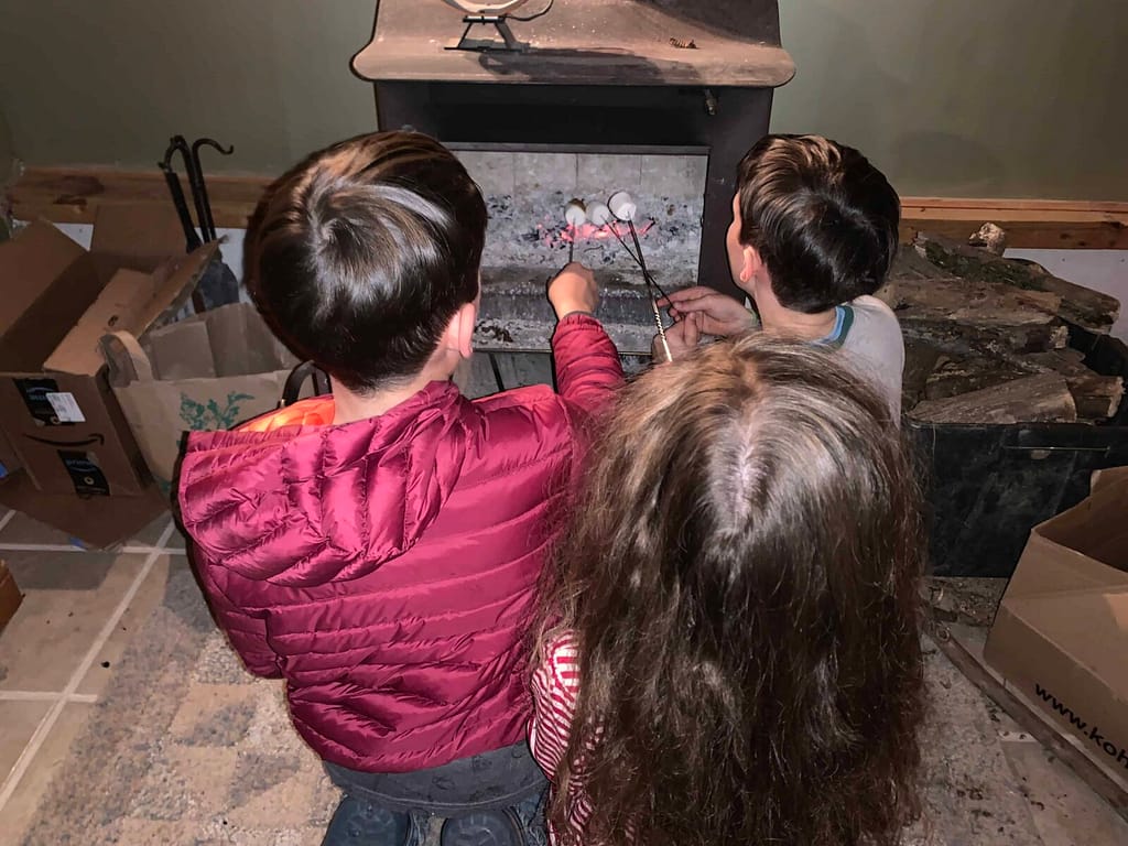 3 kids roasting marshmallows
