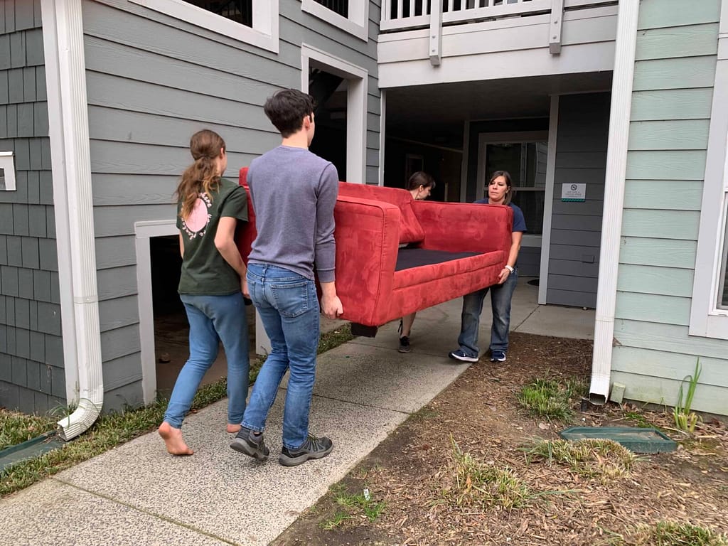 family moving couch into apartment