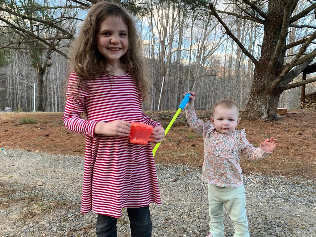 6 year old playing with a 1 year old outside