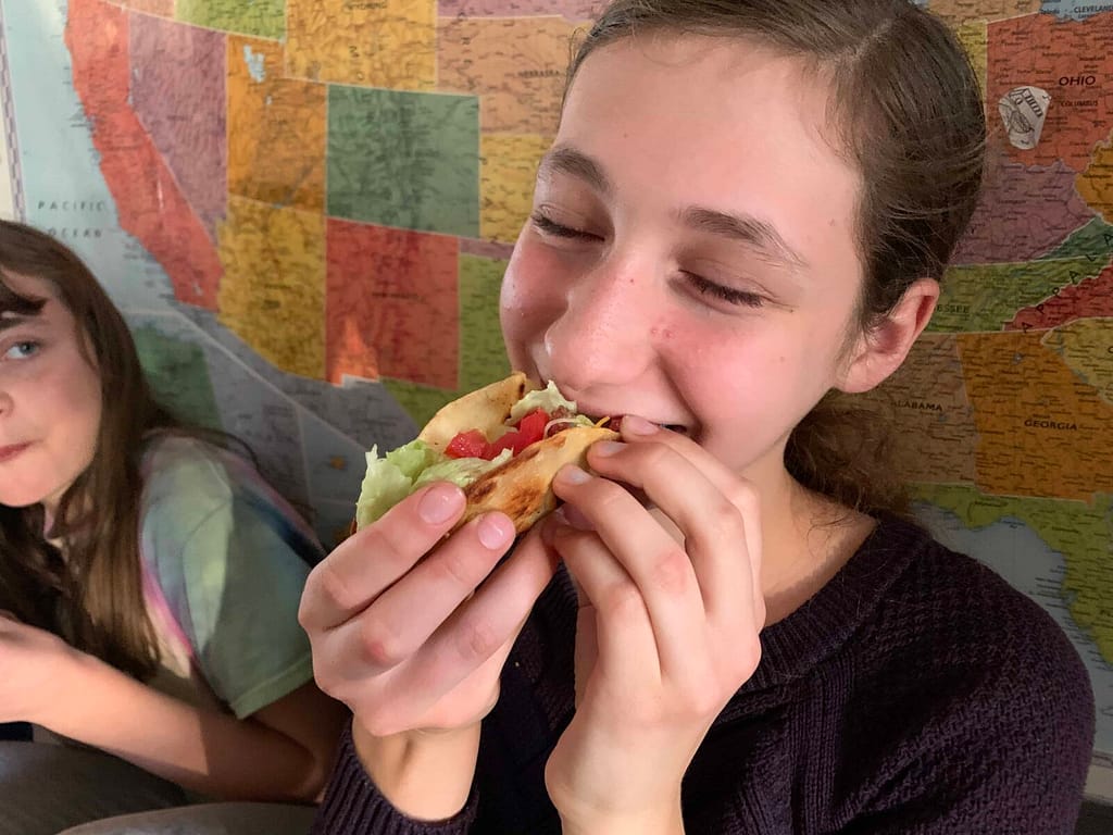 13 year old girl eating a taco