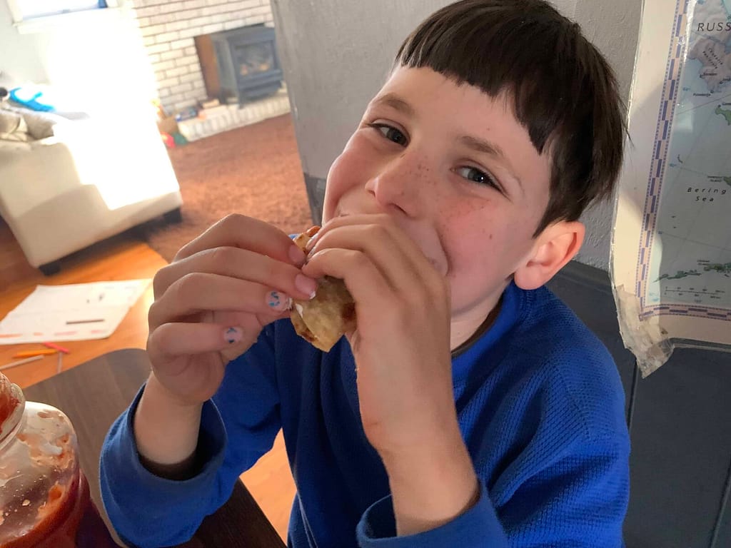 8 year old boy eating a taco